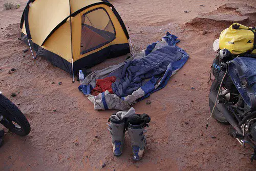 Sleeping under the starts outside the tent on an adventure bike trip through Sudan